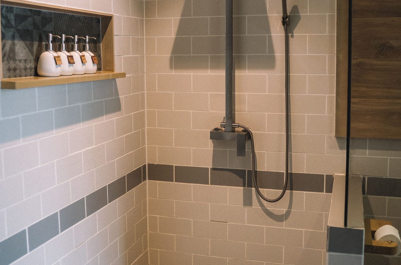 Dusch med beige metrokakel och en accentrand